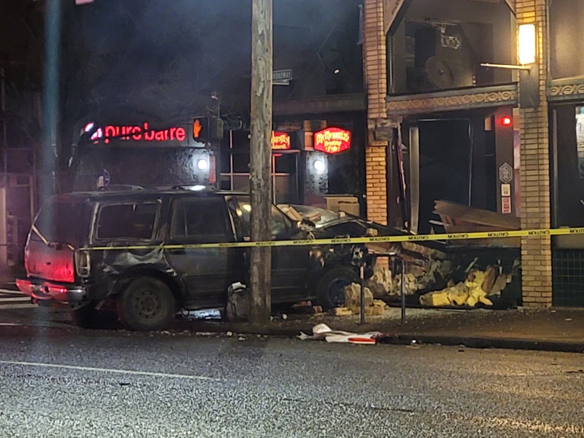 On NE 15th & Broadway a vehicle has crashed into the Bar name Capital &amp; destroyed some of the building. The brick built corner has crumbled on top of the car that crashed. Appears a 2nd car was involved. Tow trucks were on the scene