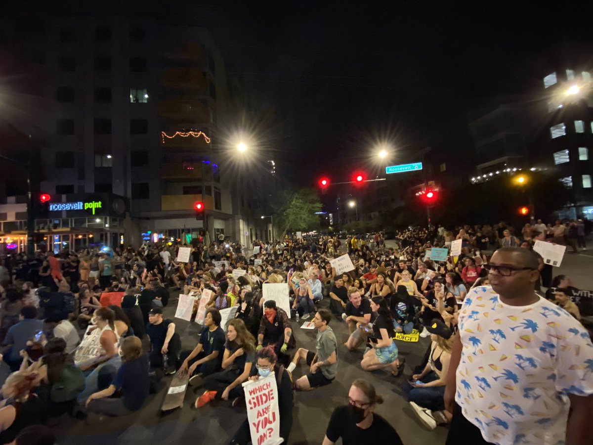 The crowd has walked down Roosevelt a few times now and have taken a seat in the middle of the intersection at 3rd street and Roosevelt. PHX PD is currently blocking all lanes of traffic